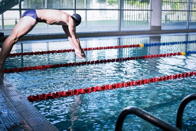 Premium Photo Fit Man Diving In The Pool