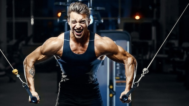 Premium Photo | Fit man doing cable crossover at the gym