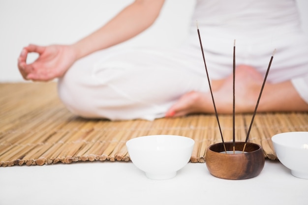 Premium Photo | Fit woman meditating on bamboo mat