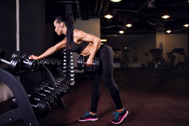 Premium Photo | Fitness girl lifting dumbbell