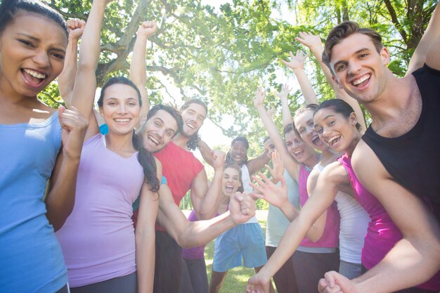 Premium Photo | Fitness group cheering at camera in park