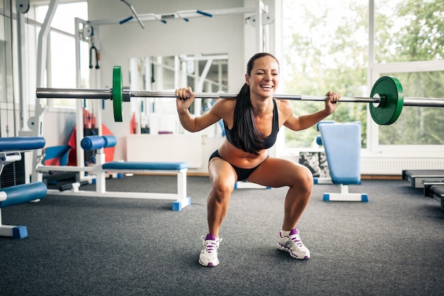 Premium Photo Fitness Woman Doing Squats With Barbell