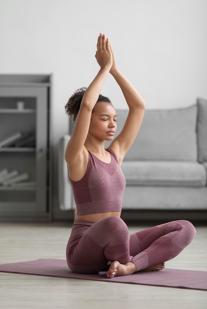 Free Photo | Fitness woman doing yoga on a yoga mat at home