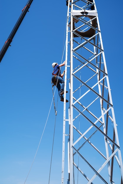 Premium Photo | Fitter climbs stairs of wind turbine truss tower ...