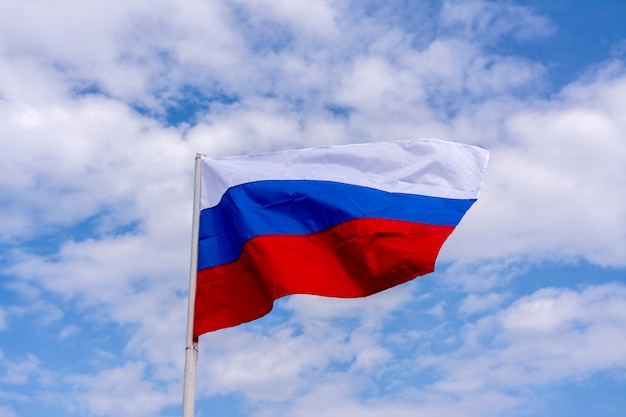 Premium Photo | The flag of russia flutters against the blue sky