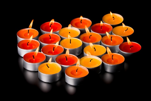 Flaming candles on black background Photo | Premium Download