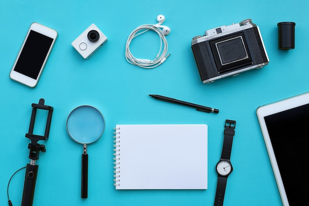 Flat lay of accessories on blue desk background Premium Photo