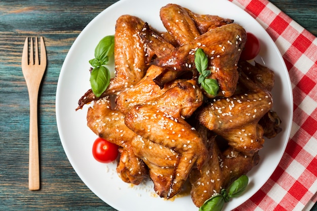Free Photo | Flat lay chicken wings on plate with sesame seeds