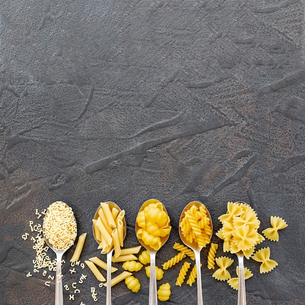 Flat lay of different types of pasta with copy space Free Photo