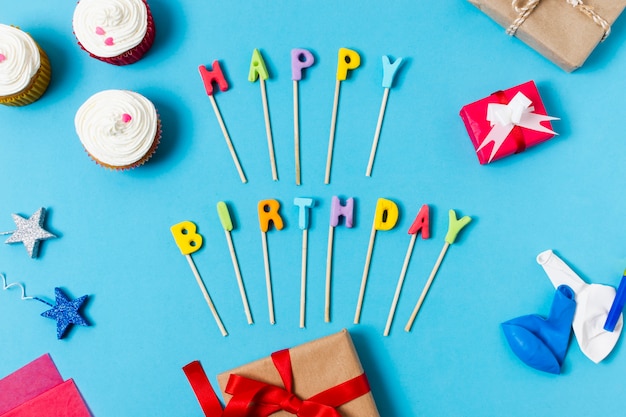 Flat lay happy birthday lettering on blue background Photo | Free Download