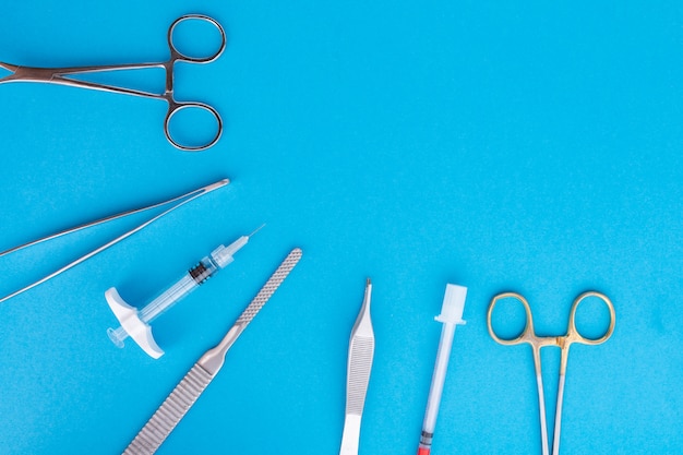 Premium Photo | Flat lay of medical instruments on blue background.