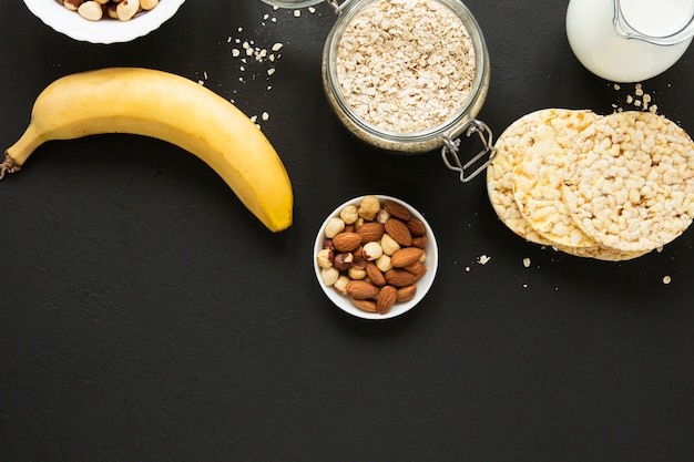 Flat lay oats jar with nuts mix and banana Free Photo