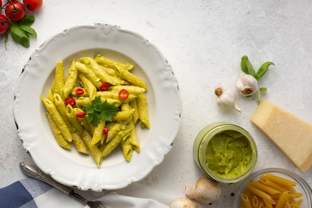 Free Photo | Flat lay penne with pesto and red peppers