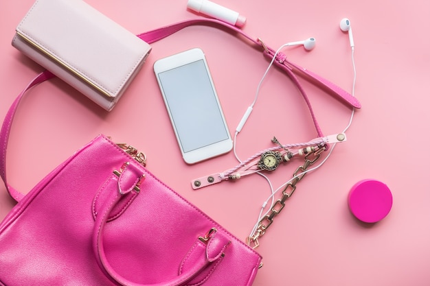 Premium Photo | Flat lay of pink woman bag open out with accessories