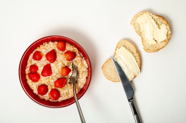 Flat lay porridge with strawberries arrangement Free Photo
