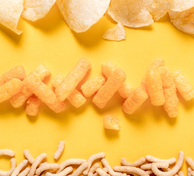 Free Photo Flat Lay Of Potato Chips And Cheesy Puffs