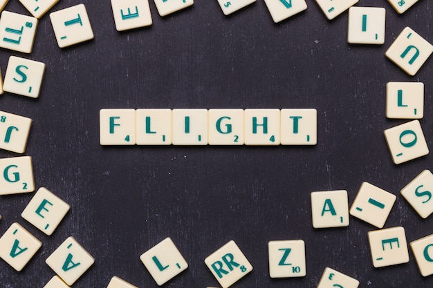 free-photo-flight-word-arranged-on-black-background-surrounded-by-scrabble-letters