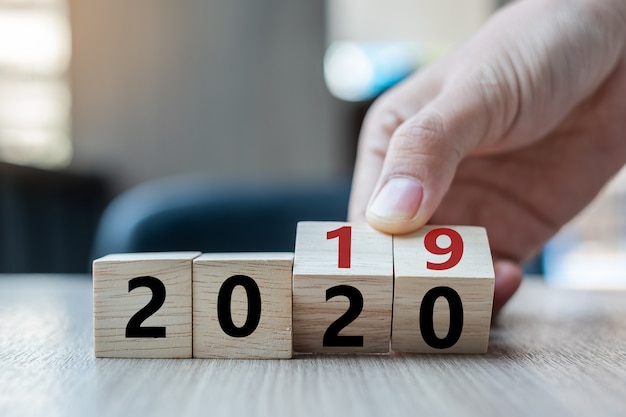 Flip over block 2019 to 2020 word on table background Premium Photo
