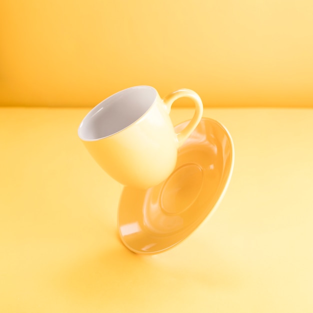 Download Free Photo A Floating Yellow Coffee Cup PSD Mockup Templates