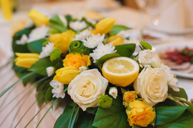 Premium Photo | Floral arrangement with flowers and half a lemon