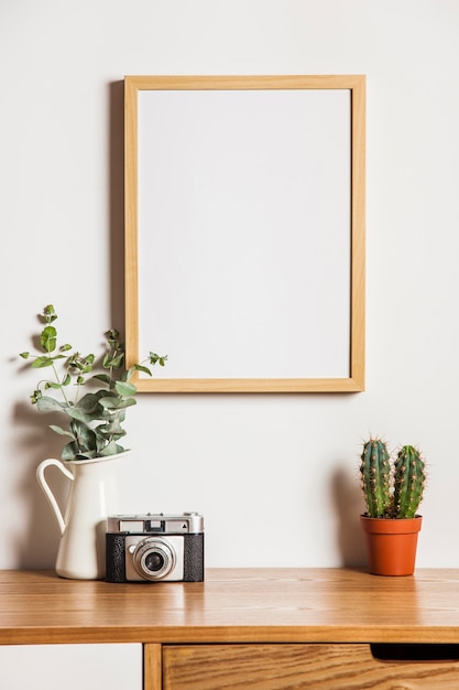 Floral composition with frame  and camera Free Photo 