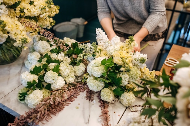 Premium Photo | Florist making bouquet in flower shop