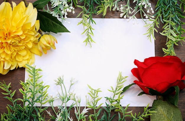 Download Flower frame with white blank paper on wood background ...