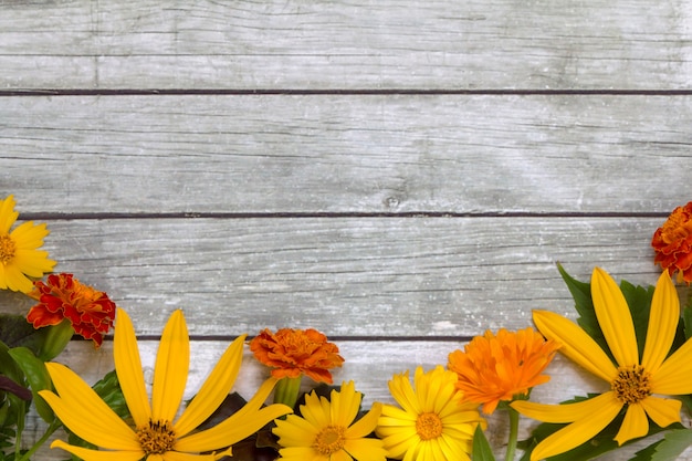 Premium Photo | Flowers on a wooden background.