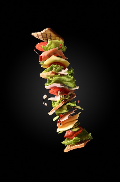 Premium Photo | Flying sandwich on dark background. creative concept.