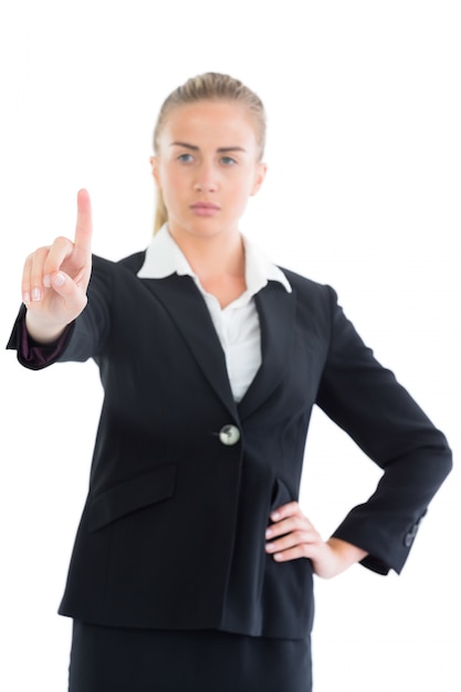 Premium Photo | Focused young business woman pointing upwards