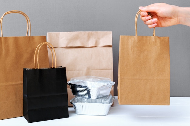 Download Premium Photo | Food delivery service. brown craft paper bag package in female hand. delivery ...