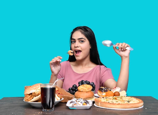 Premium Photo Foodie Girl Sitting At Fruit Table Eating Mini Donut Indian Pakistani Model 