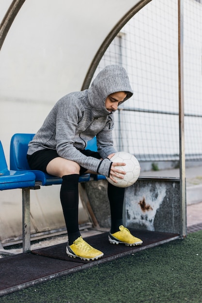 Football Player On Bench Free Photo