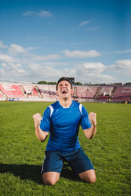 Football Player Celebrating Goal On Knees Photo Free Download 