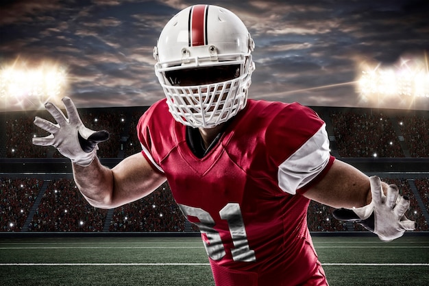 Premium Photo | Football player with a red uniform making a tackle on a ...