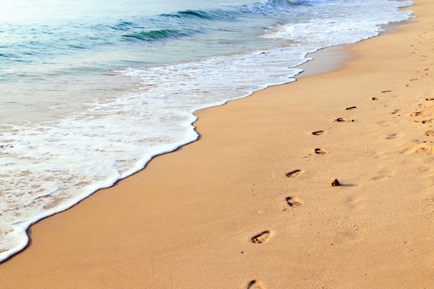 Footprints on the beautiful sand beach Photo | Premium ...