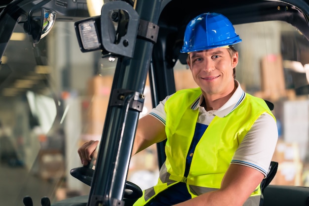 Premium Photo | Forklift driver in protective vest and forklift at ...