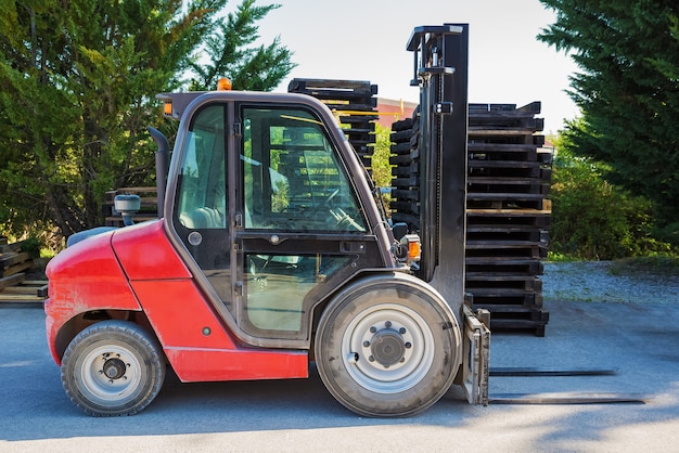Premium Photo Forklift Standing Outdoors With Wooden Pallets