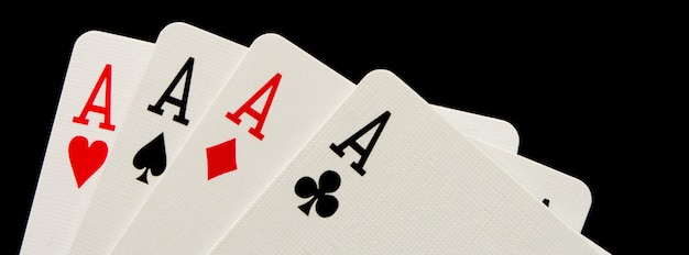 Premium Photo | Four aces on black background