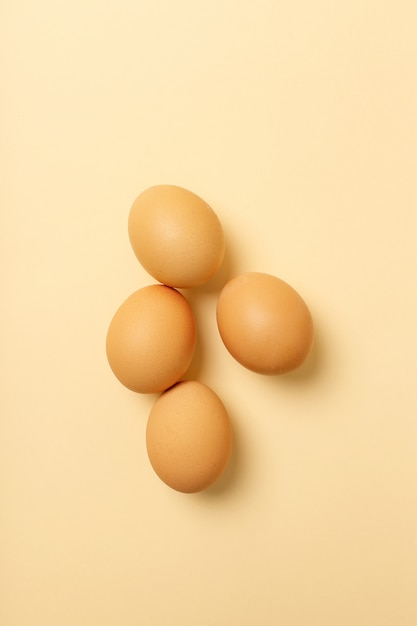 Free Photo | Four eggs isolated on yellow surface