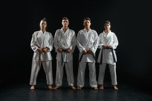 Premium Photo Four Karatekas In White Kimono Group Training Karate