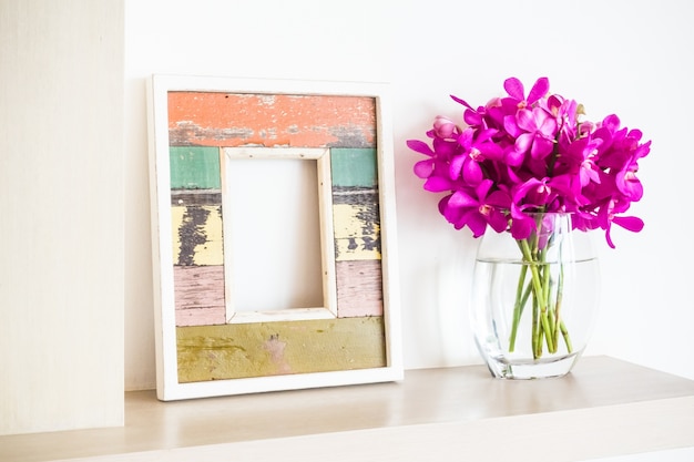 Free Photo | Frame and flower pot with flowers