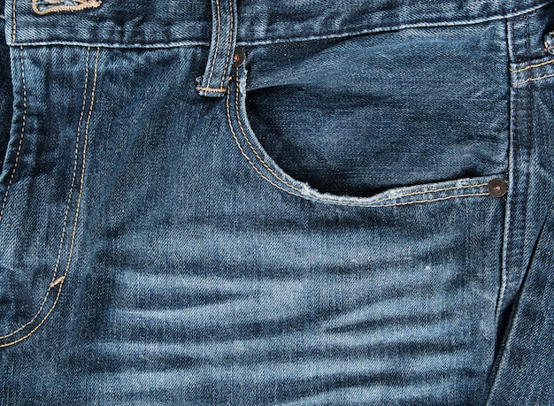 Premium Photo | Frayed empty front pocket of blue jeans