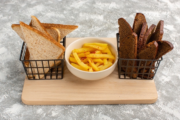French fries inside white plate along with black and white bread Free Photo