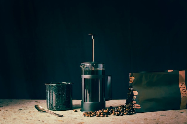 French press, coffee beans and cup Premium Photo
