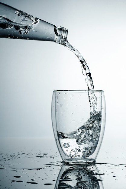 Premium Photo | Fresh and cold, pure water is poured into a glass ...
