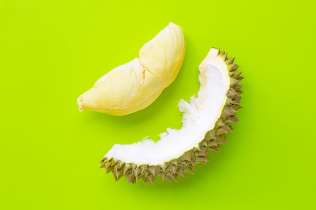 Premium Photo | Fresh cut durian on green background.