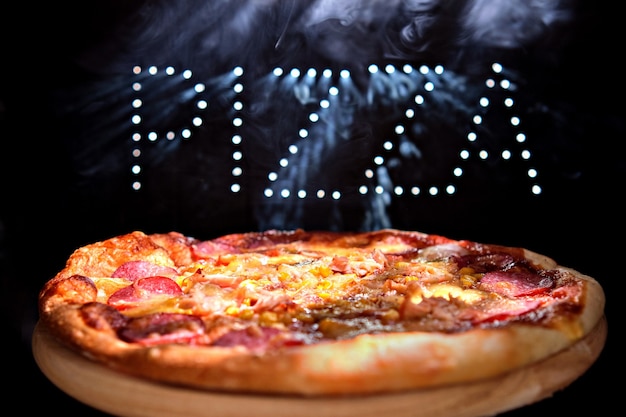 Premium Photo | Fresh delicious italian pizza on a black background ...