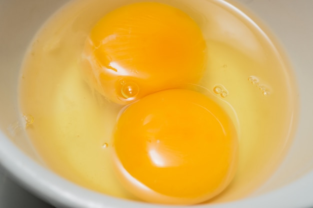 Premium Photo | Fresh eggs, twin egg yolk in glasses bowl