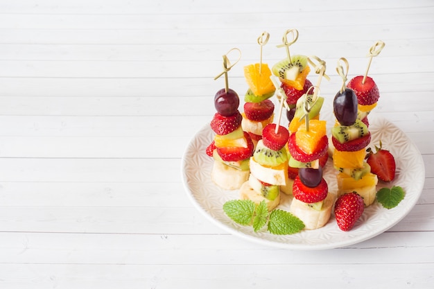 Premium Photo | Fresh fruit on skewers